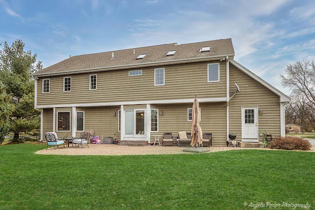 back of property featuring a lawn and a patio area