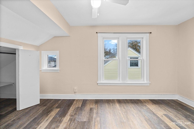 additional living space with ceiling fan, dark hardwood / wood-style flooring, and vaulted ceiling