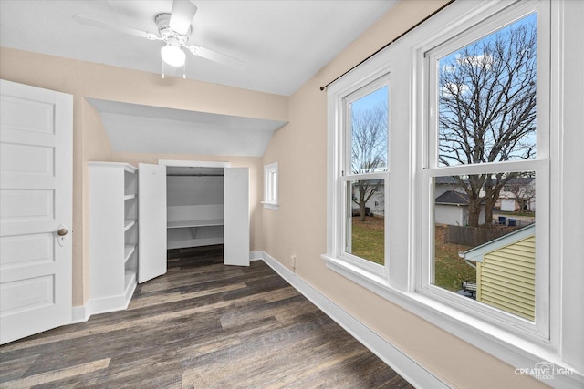 unfurnished bedroom featuring ceiling fan, dark hardwood / wood-style flooring, and lofted ceiling