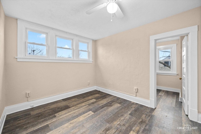 unfurnished bedroom with multiple windows, a textured ceiling, dark hardwood / wood-style flooring, and ceiling fan