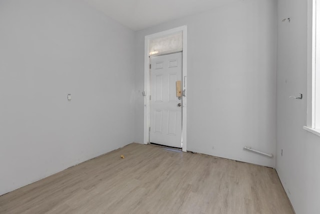 empty room with light hardwood / wood-style flooring