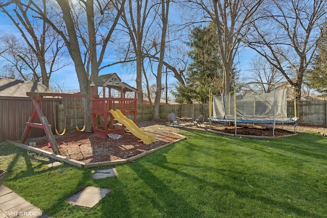 view of playground with a trampoline and a yard