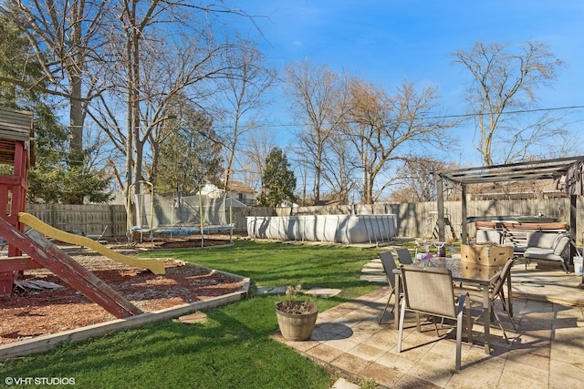 view of yard with a playground, a patio area, and a trampoline