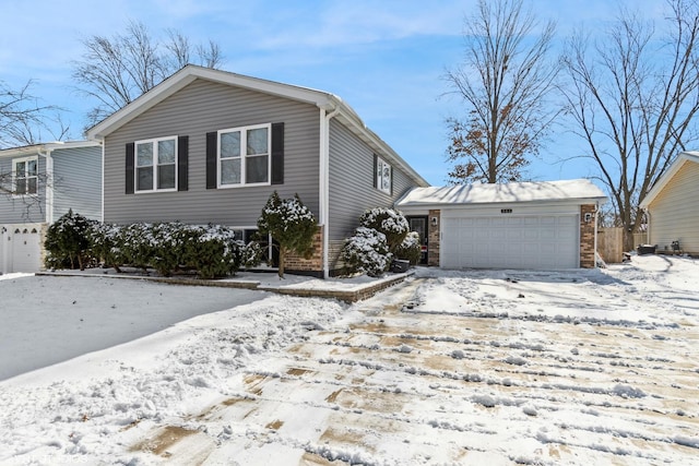 view of front of home with a garage and brick siding