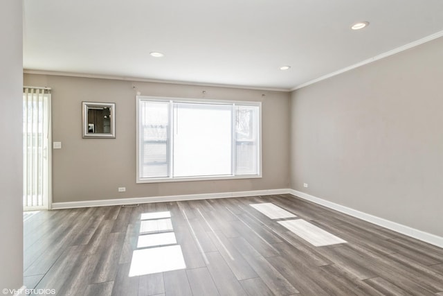 spare room featuring baseboards and wood finished floors