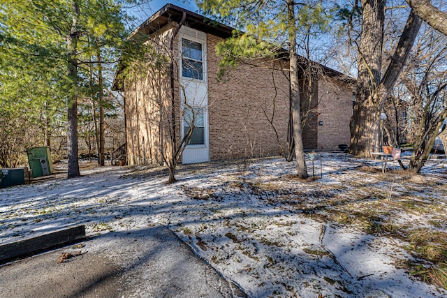 view of snow covered rear of property