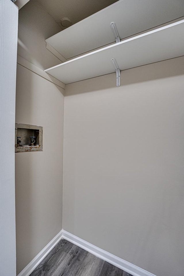 clothes washing area featuring dark wood-type flooring and hookup for a washing machine