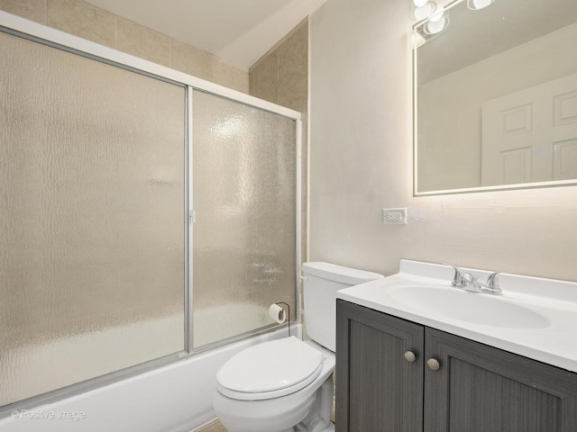 full bathroom with shower / bath combination with glass door, vanity, and toilet