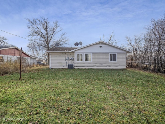 back of house with a lawn and central AC unit