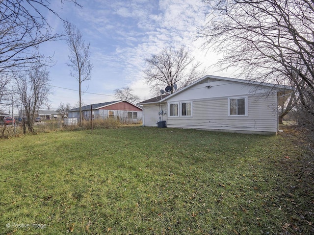 rear view of property with a lawn