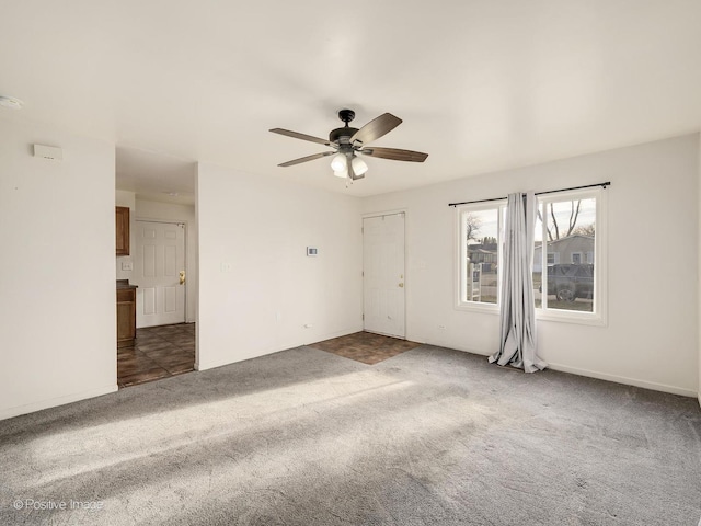 carpeted spare room with ceiling fan