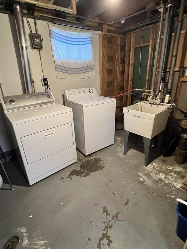 laundry room with washing machine and clothes dryer and sink