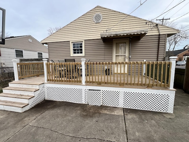 rear view of property featuring a deck