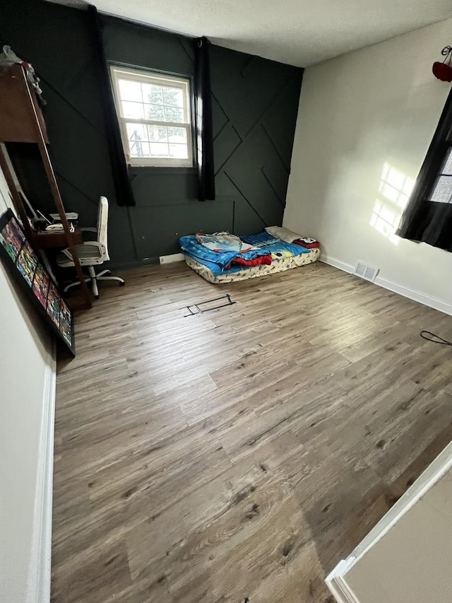 unfurnished bedroom with hardwood / wood-style flooring