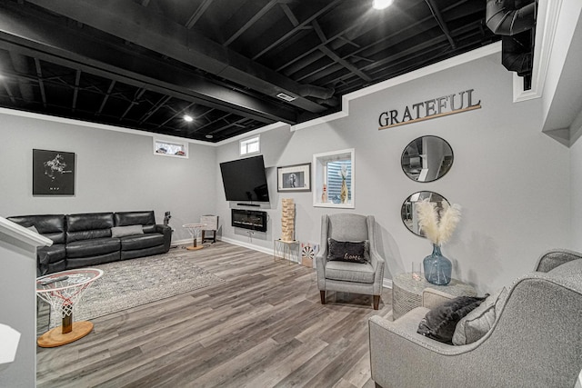 living room featuring wood-type flooring and ornamental molding