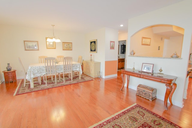 dining space with a chandelier and light hardwood / wood-style flooring