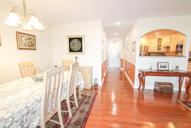 dining space featuring a chandelier and light hardwood / wood-style floors