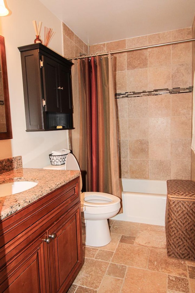 full bathroom featuring shower / bath combo, vanity, and toilet