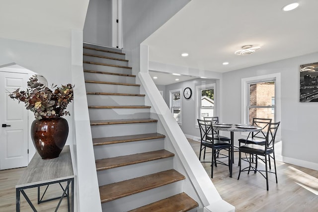 stairs featuring hardwood / wood-style floors