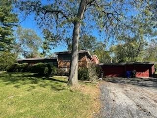 view of side of home with a lawn