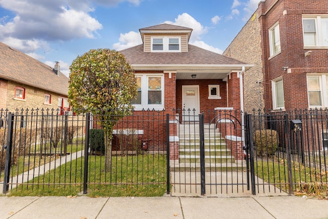 bungalow-style home with a front yard