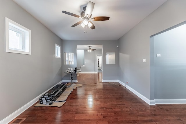 corridor with dark hardwood / wood-style flooring