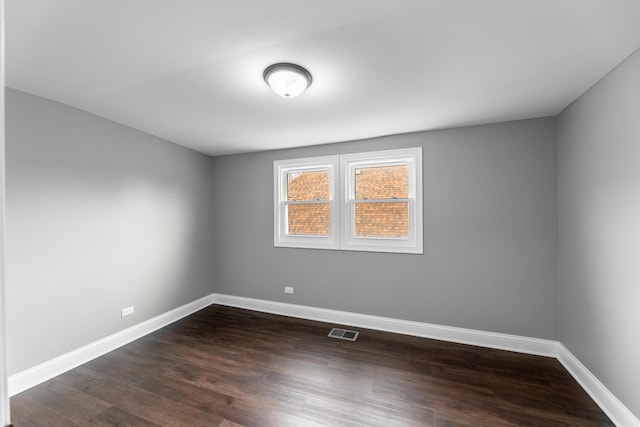 empty room featuring dark wood-type flooring