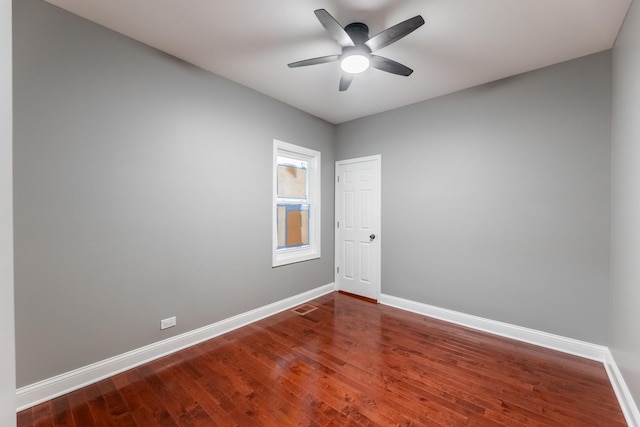 spare room with hardwood / wood-style floors and ceiling fan