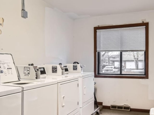 clothes washing area with washing machine and clothes dryer