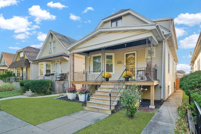 bungalow-style home featuring a porch and a front lawn