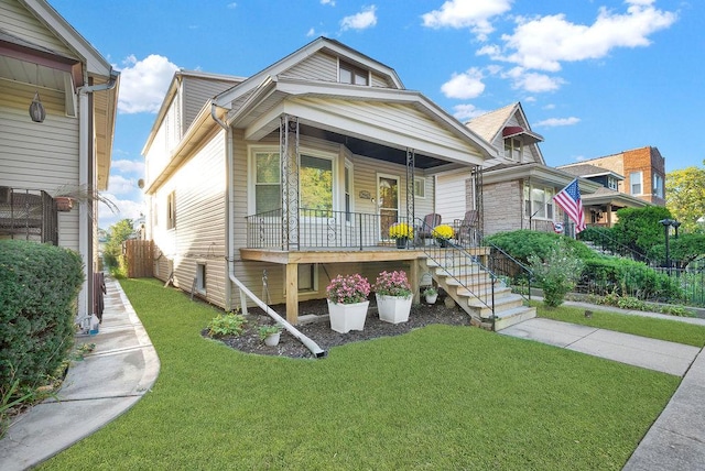 view of front of property featuring covered porch and a front lawn