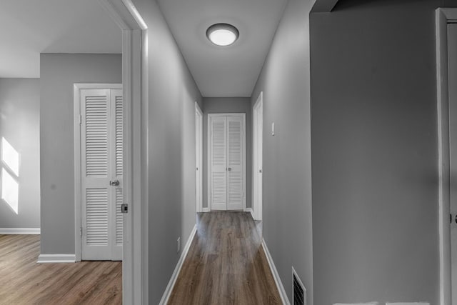 hallway with wood-type flooring