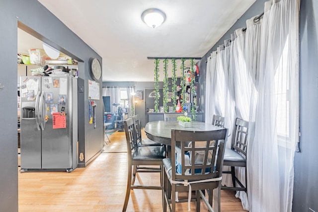 dining space featuring a healthy amount of sunlight and hardwood / wood-style flooring