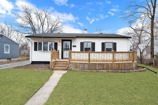 view of front facade with a front lawn and a deck