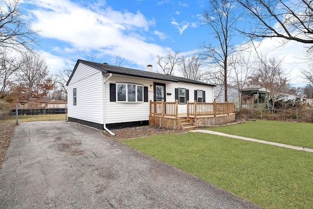 view of front of house featuring a front yard and a deck