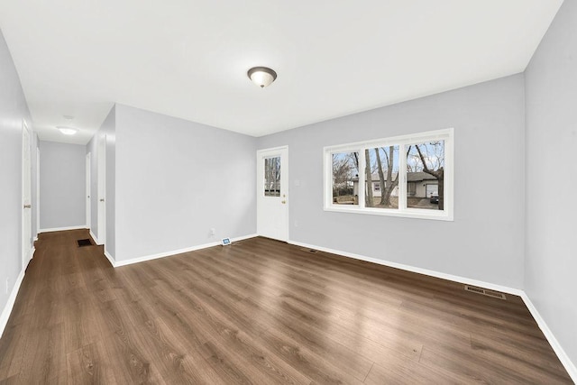 spare room with dark hardwood / wood-style floors