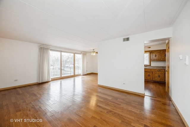 spare room with ceiling fan and hardwood / wood-style flooring