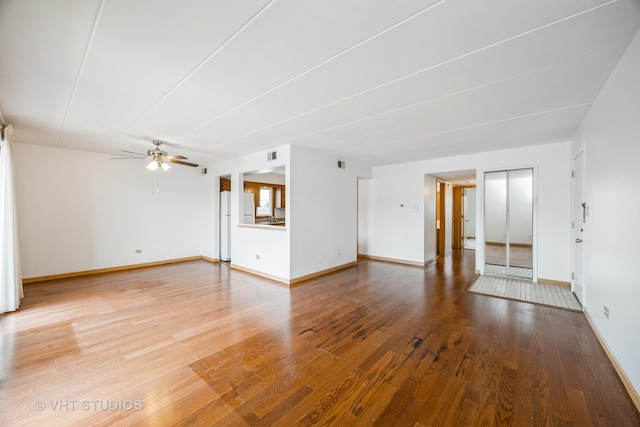 unfurnished living room featuring hardwood / wood-style floors and ceiling fan