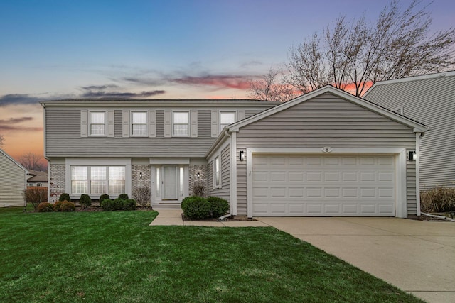 front facade with a yard and a garage