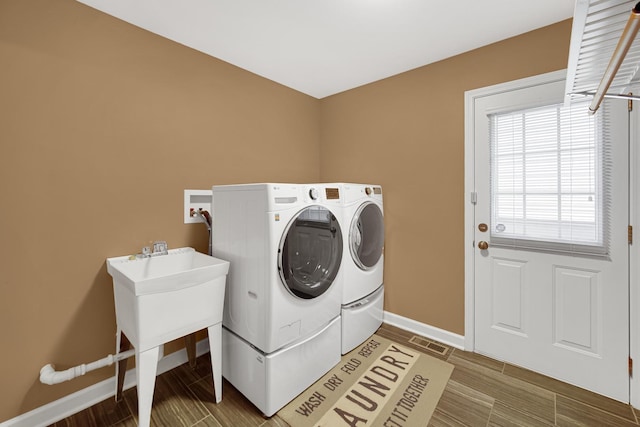 laundry room with wood-type flooring and washing machine and clothes dryer