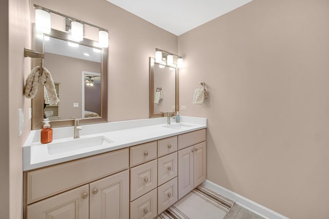 bathroom featuring tile patterned flooring, vanity, and ceiling fan