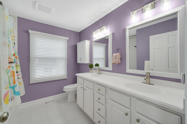 bathroom featuring toilet, vanity, and tile patterned floors