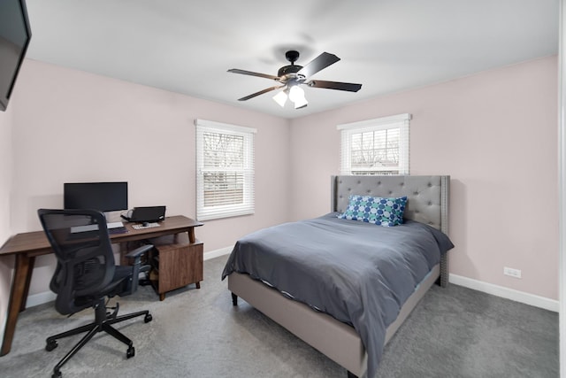 carpeted bedroom featuring multiple windows and ceiling fan