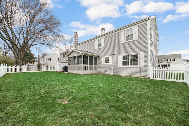 back of property with a sunroom and a yard