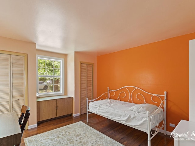 bedroom with dark hardwood / wood-style floors