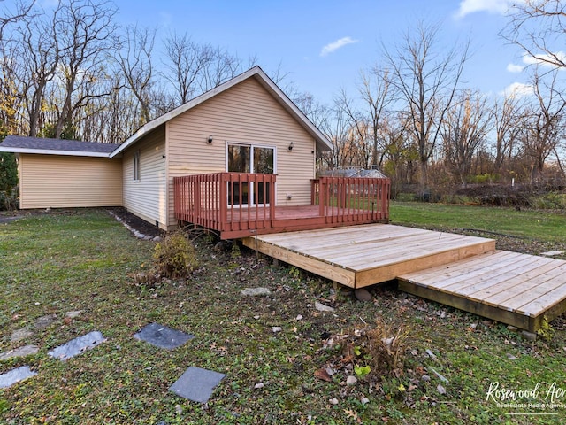 back of house featuring a deck and a yard