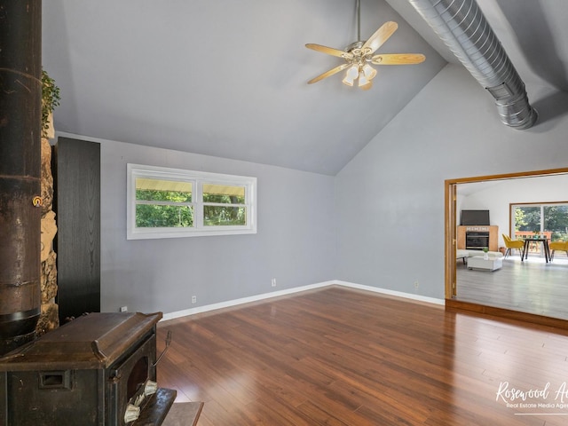 living room with hardwood / wood-style floors, ceiling fan, a healthy amount of sunlight, and high vaulted ceiling