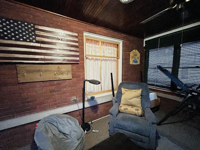 living area with carpet floors and wooden walls