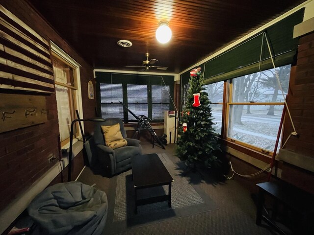 sunroom with ceiling fan and wood ceiling