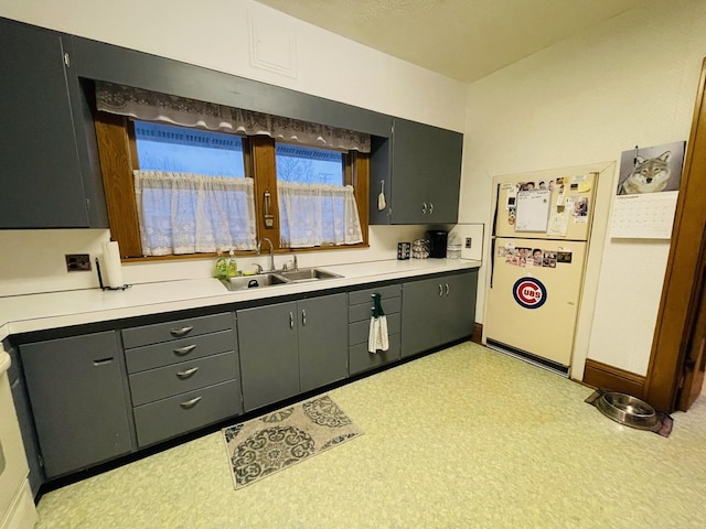 kitchen with sink and white fridge